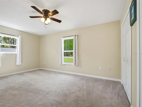 a view of a livingroom with a ceiling fan and window