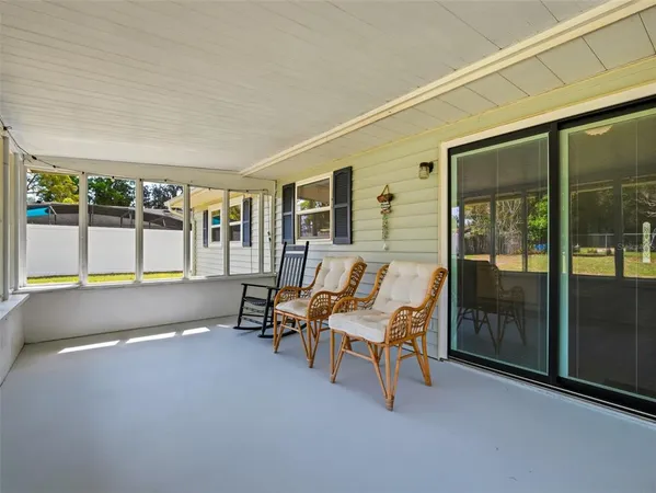 a balcony with chairs and a table