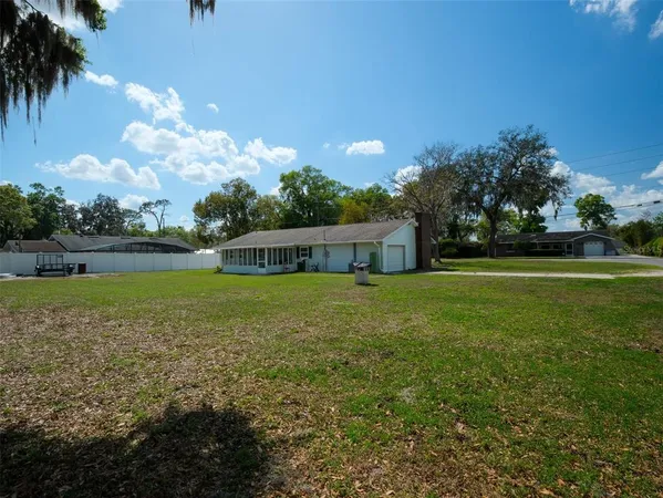 a backyard of a house with yard and tree s