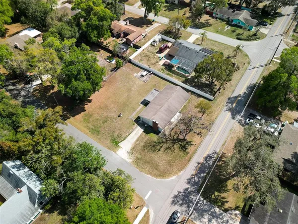 an aerial view of a house with a yard