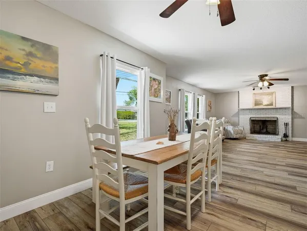 a living room with furniture a fireplace and a table