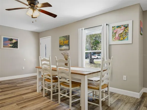 a view of a dining room with furniture and wooden floor