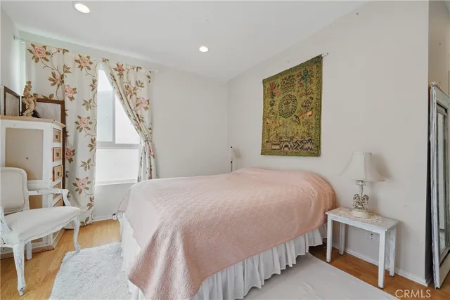 a bedroom with a large bed and a wooden floor