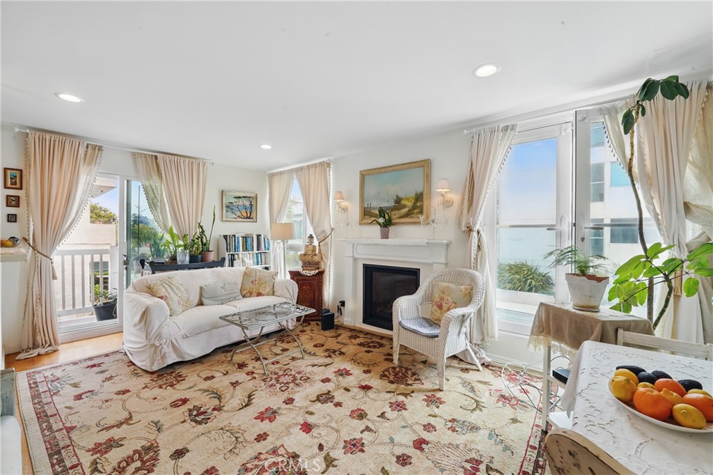 1 Jib Street, Unit 103 Marina del Rey, CA 90292 - Photo 4 of 26 a living room with furniture and a fireplace