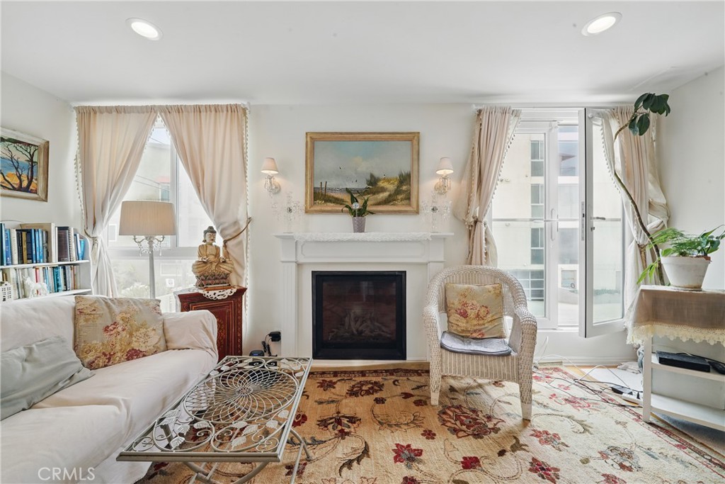 1 Jib Street, Unit 103 Marina del Rey, CA 90292 - Photo 5 of 26 a living room with furniture and a fireplace