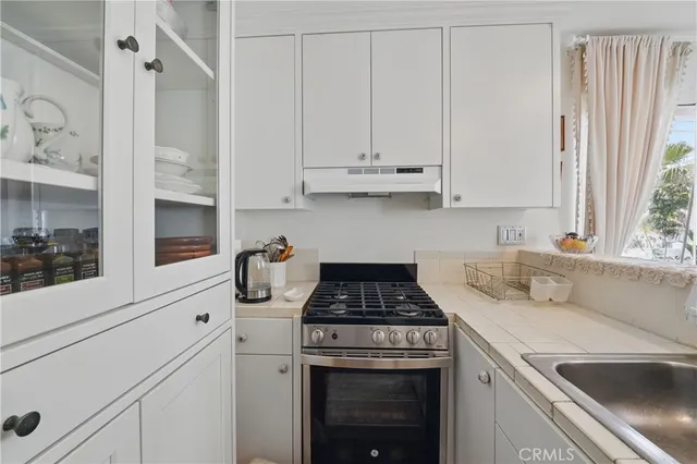 a kitchen with a sink cabinets and window