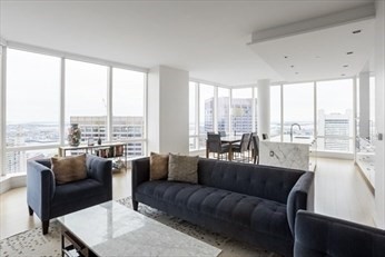 1 Franklin Street, Unit 5105 Boston, MA 02110 - Photo 3 of 24 a living room with furniture and a large window