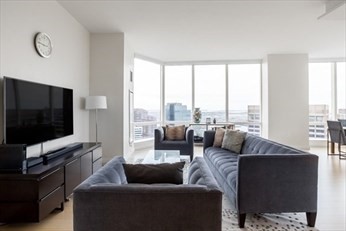 1 Franklin Street, Unit 5105 Boston, MA 02110 - Photo 4 of 24 a living room with furniture and a flat screen tv