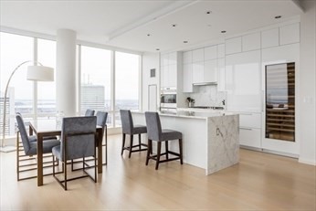 1 Franklin Street, Unit 5105 Boston, MA 02110 - Photo 5 of 24 a view of kitchen with granite countertop furniture dining table and stainless steel appliances