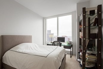 1 Franklin Street, Unit 5105 Boston, MA 02110 - Photo 8 of 24 a bed room with a bed and a window