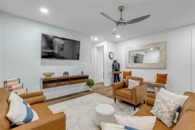 a living room with furniture and a wooden floor