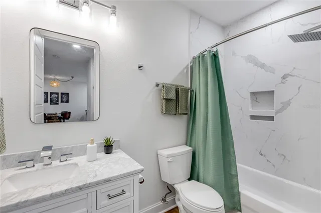 a bedroom with a bed and a night stand