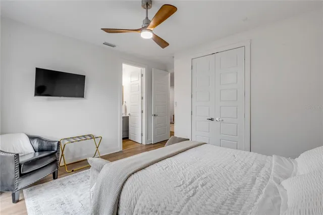 a bedroom with a bed and a flat screen tv