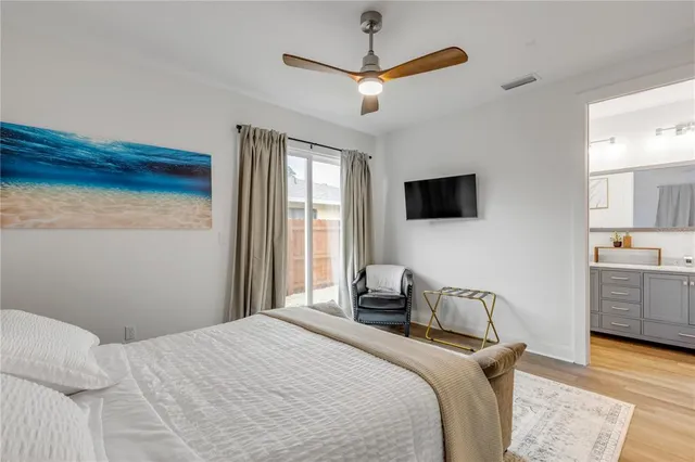 a bedroom with a bed and a painting on the wall