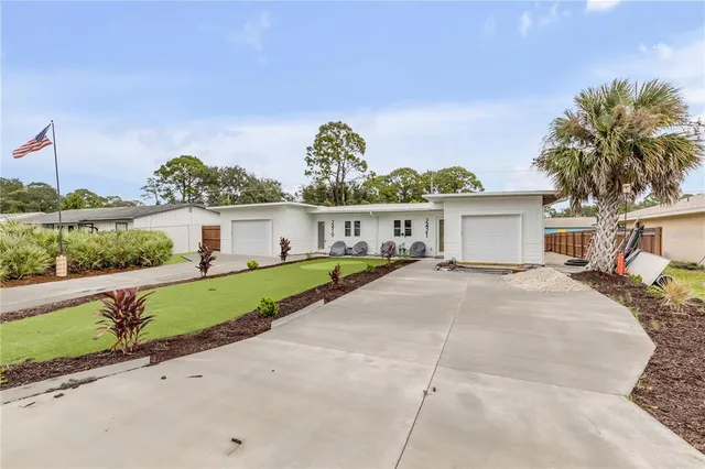 a front view of a house with a garden and yard