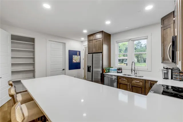 a large white kitchen with stainless steel appliances