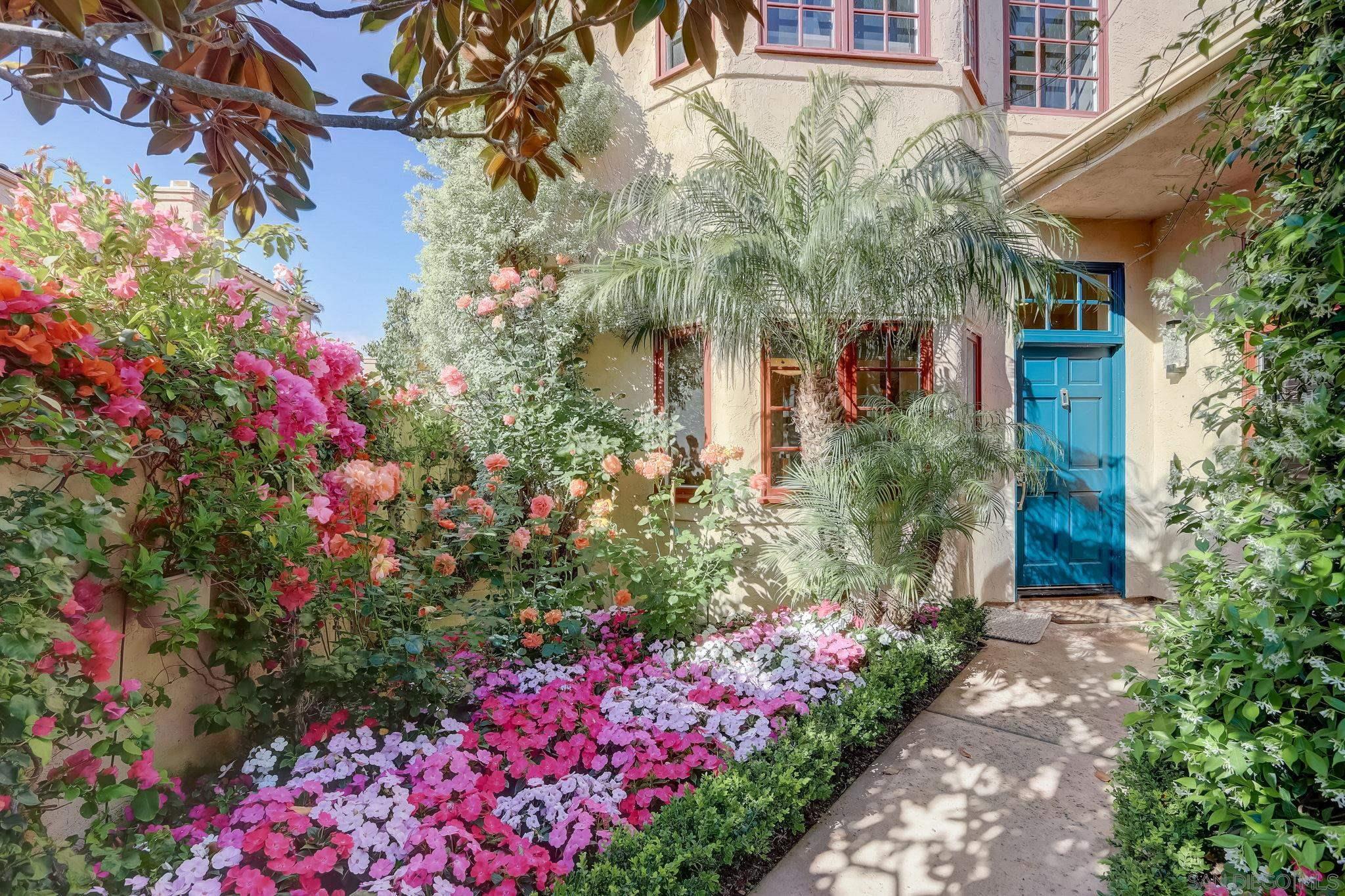 a view of a house with a lot of flower plants