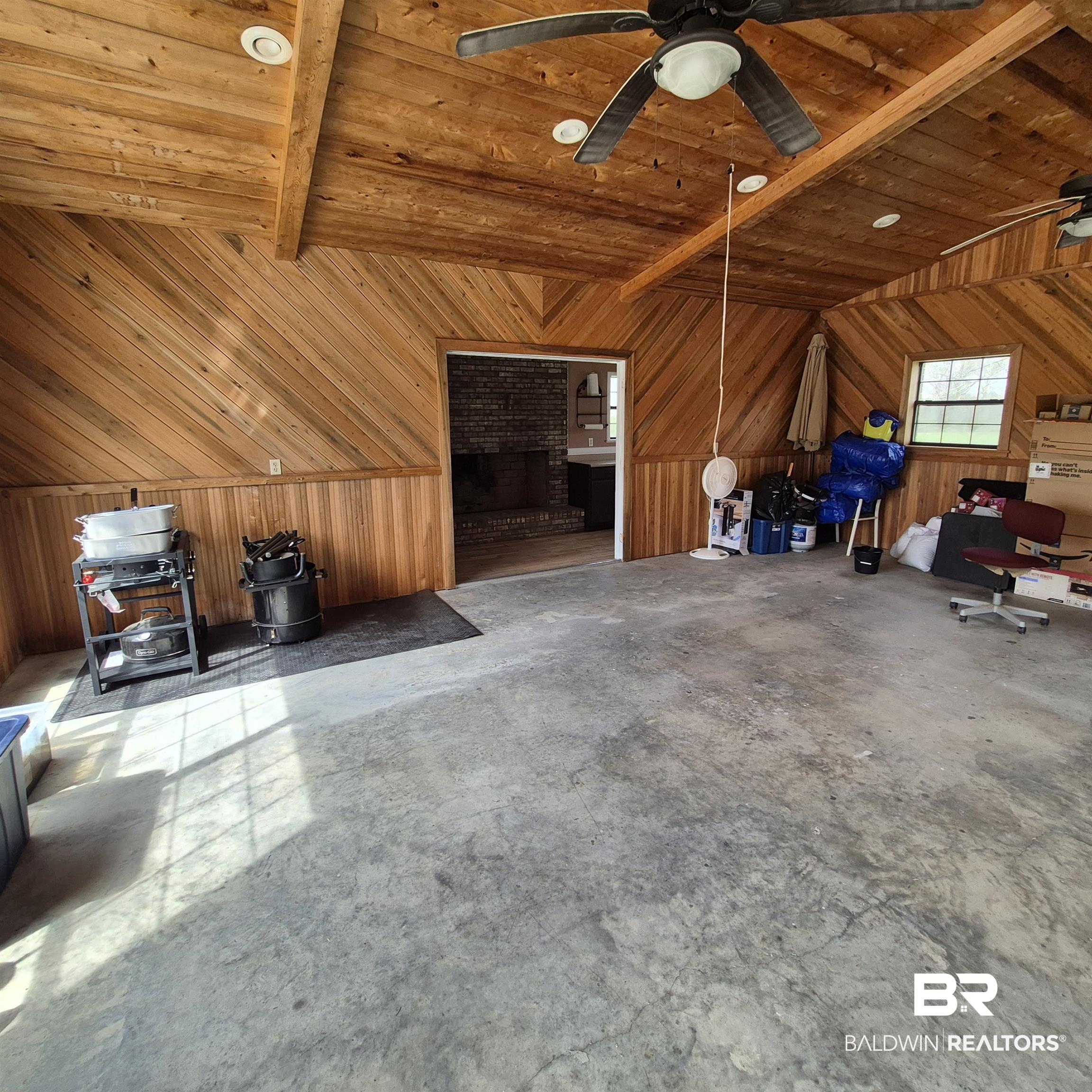 26635 Highway 41 Range, AL 36473 - Photo 45 of 74 Bonus room featuring wooden walls, unfinished concrete flooring, wooden ceiling, vaulted ceiling with beams, and a ceiling fan