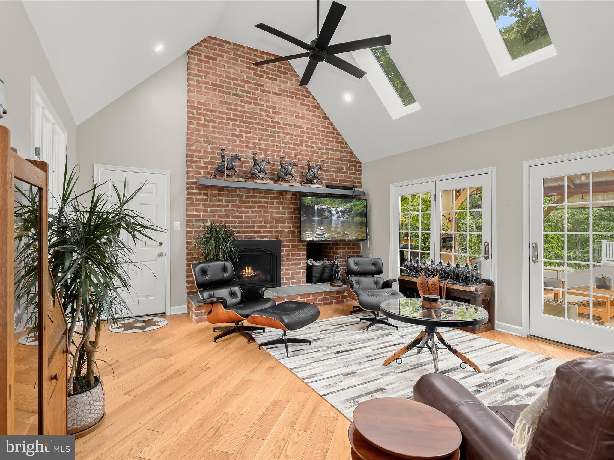 10901 Moxley Road Damascus, MD 20872 - Photo 12 of 148 a living room with furniture floor to ceiling window and a fireplace
