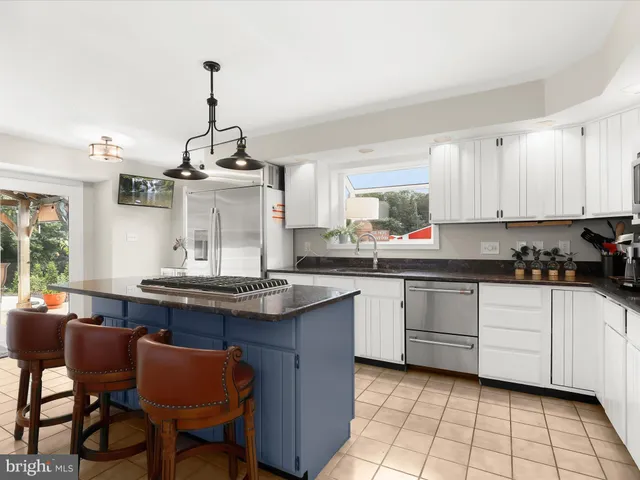 a outdoor space with the couches and dining table with the garden view