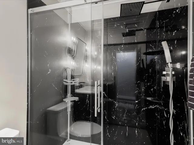 a view of a wooden house with large trees and a small yard