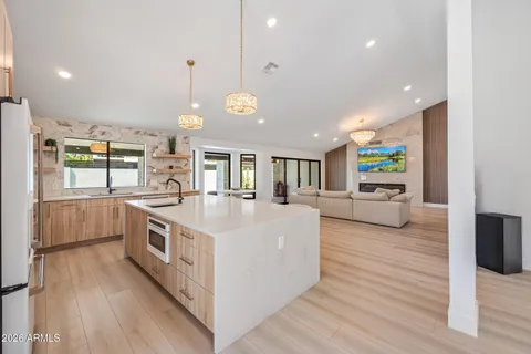 a large white kitchen with kitchen island and a stove