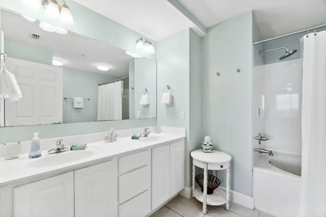 a bathroom with a double vanity sink mirror and toilet
