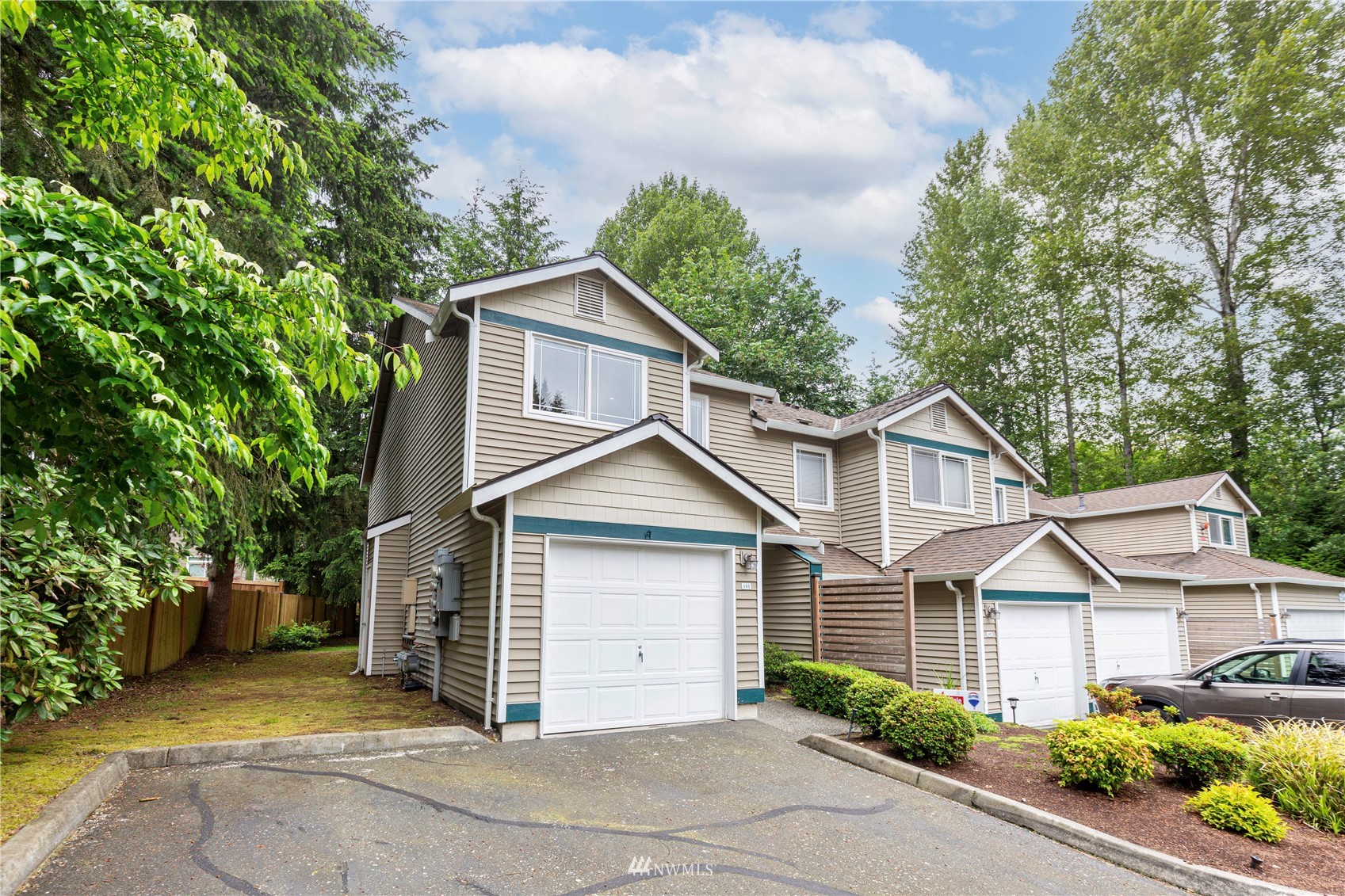 21608 9th Avenue Southeast, Unit B101 Bothell, WA 98021 - Photo 21 of 23 a view of a house with a yard and large tree
