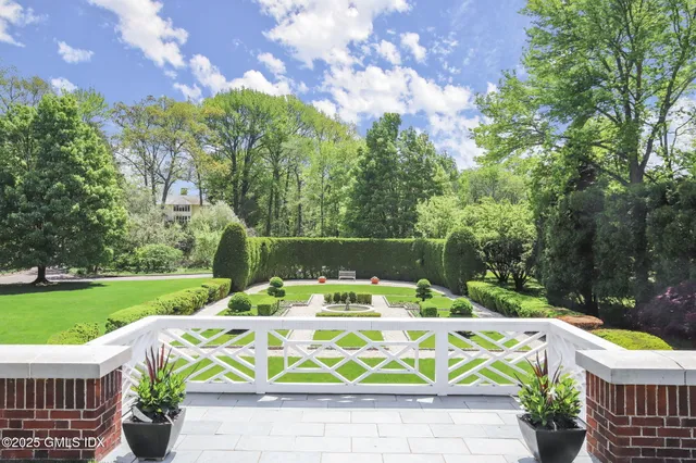 a view of a outdoor space with a garden and sitting area