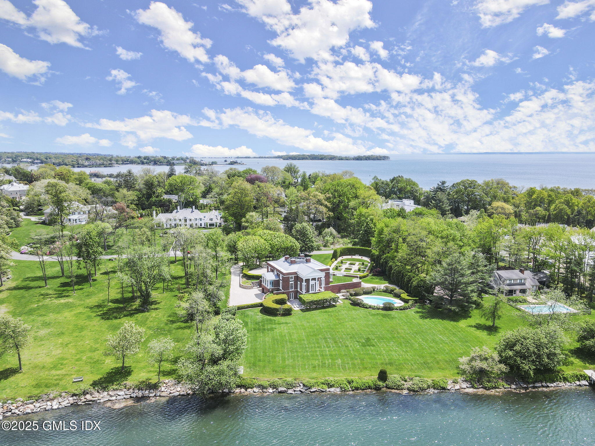 16 Windrose Way Greenwich, CT 06830 - Photo 2 of 18 a view of a garden with a building in the background