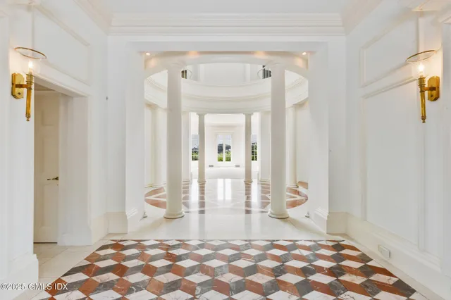 a bedroom with a bed and a mirror on the dresser