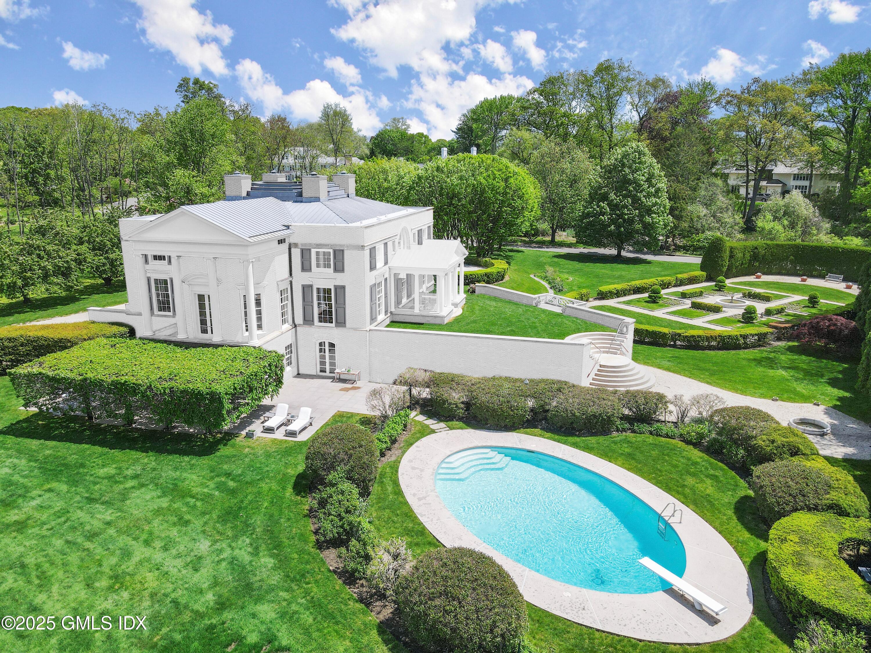 16 Windrose Way Greenwich, CT 06830 - Photo 4 of 11 an aerial view of a house with swimming pool and a yard