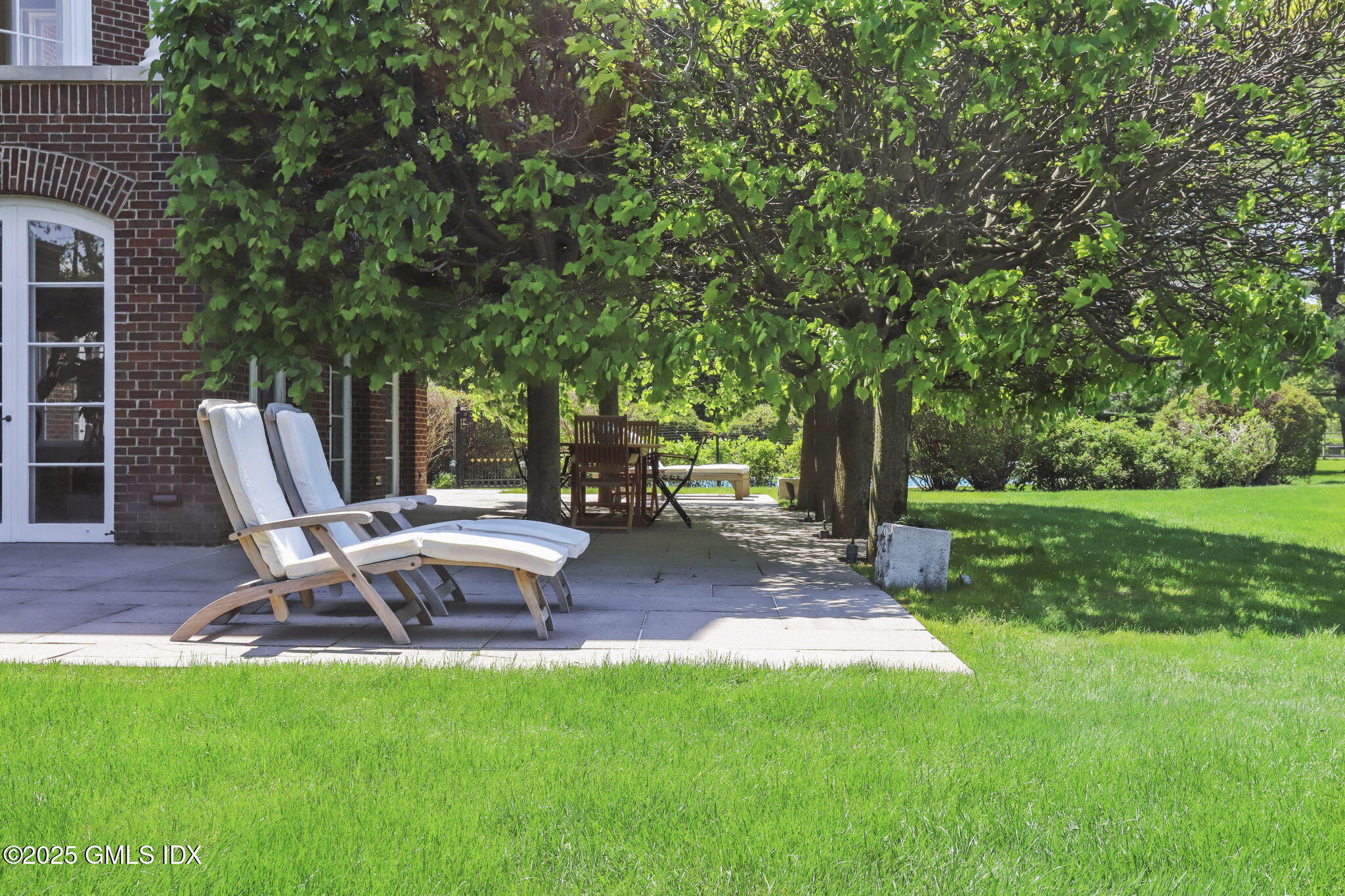 16 Windrose Way Greenwich, CT 06830 - Photo 7 of 11 a view of a outdoor space with a garden and sitting area