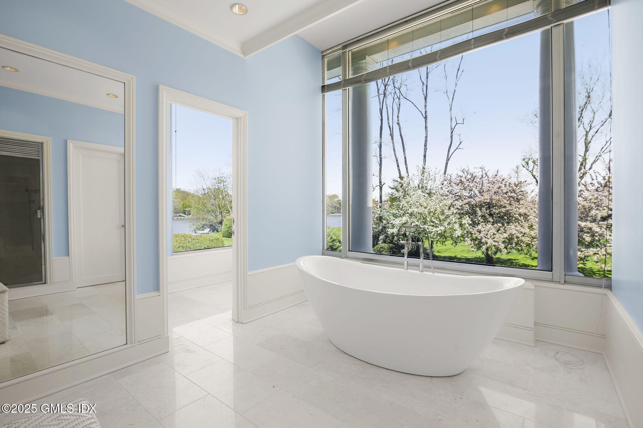 16 Windrose Way Greenwich, CT 06830 - Photo 9 of 18 a white bath tub sitting in a bathroom next to a window