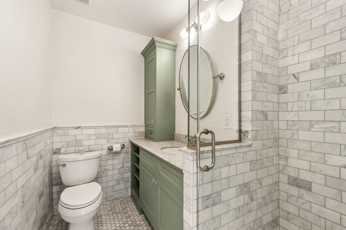 240 West St Charles Road Elmhurst, IL 60126 - Photo 22 of 41 a bathroom with a sink a toilet and a mirror