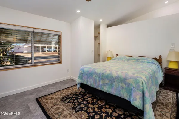 a bedroom with a bed and glass window