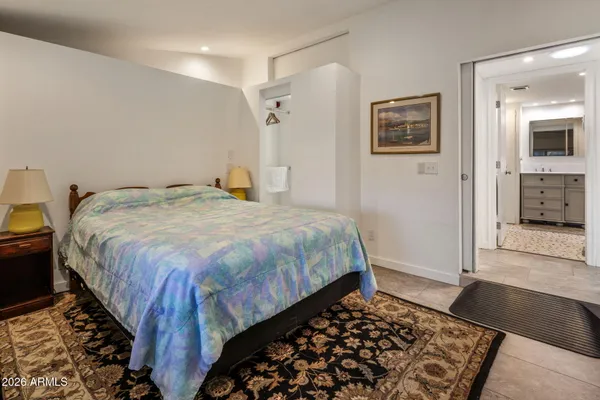 a bedroom with a bed and a view of bathroom