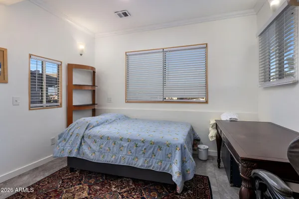 a bedroom with a bed and a table in it