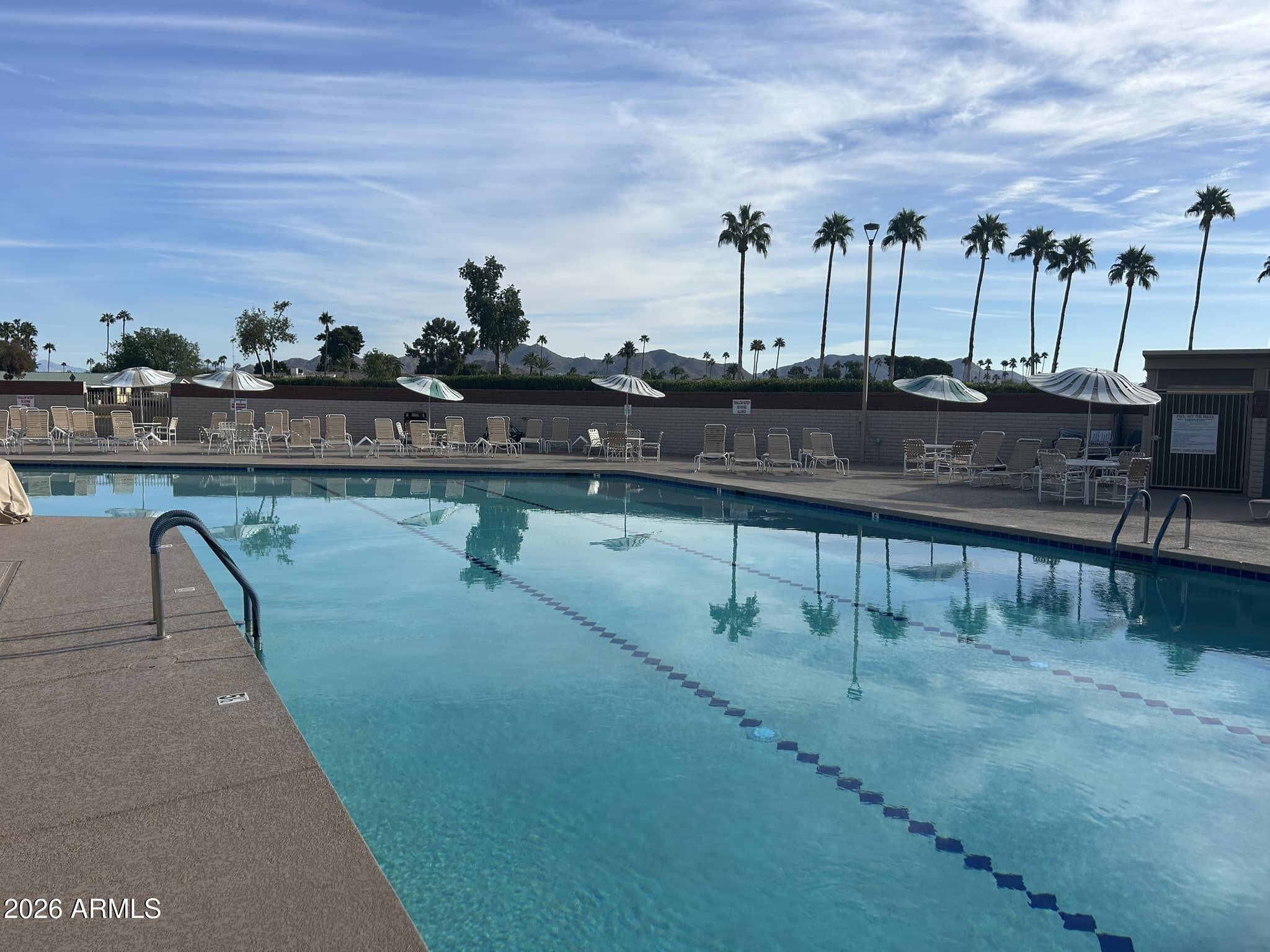 2311 North Gayridge Road Mesa, AZ 85215 - Photo 23 of 31 a view of a swimming pool with a table and chairs