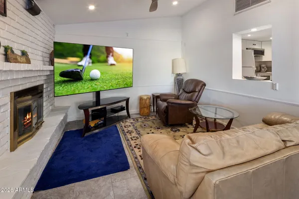 a living room with furniture fireplace and flat screen tv