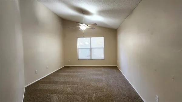 an empty room with windows and closet