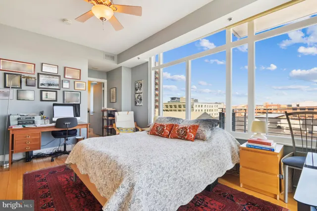 a bedroom with a large bed and a chandelier