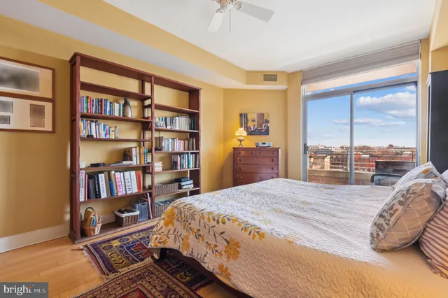 a bedroom with a bed furniture and a book shelf