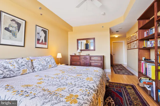 a bedroom with a bed and a book shelf
