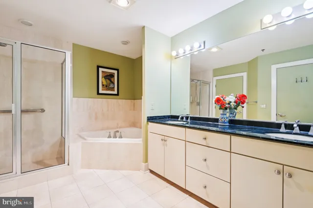 a bathroom with a bathtub shower sink and mirror