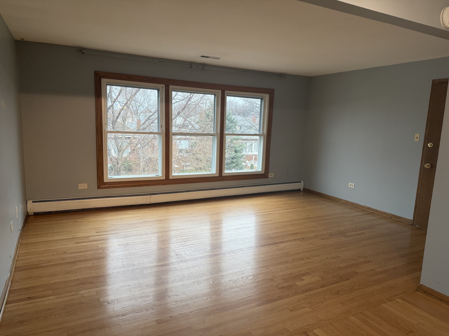 5124 South Kostner Avenue, Unit 2 Chicago, IL 60632 - Photo 3 of 12 a view of empty room with wooden floor and fan
