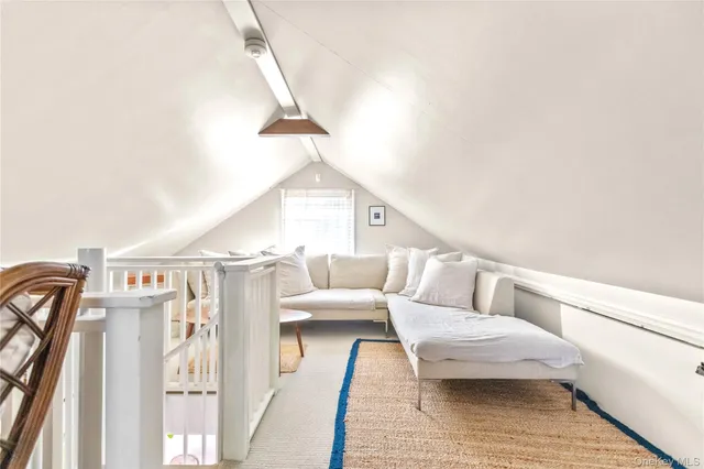 a living room with furniture and a rug