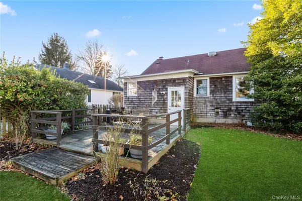 a view of a house with backyard and sitting area
