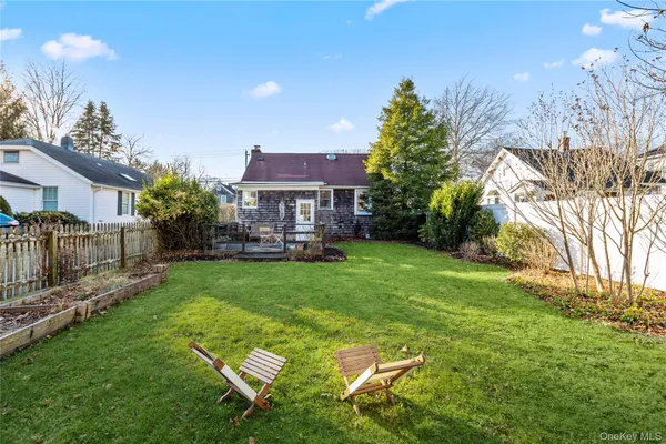a view of a house with a backyard and a patio