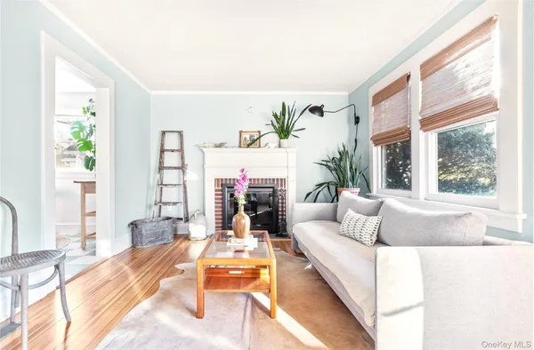 a living room with fireplace furniture and a large window